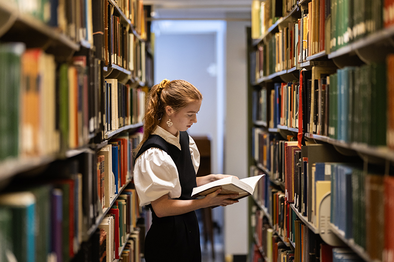 Girl with book in Ellis Library