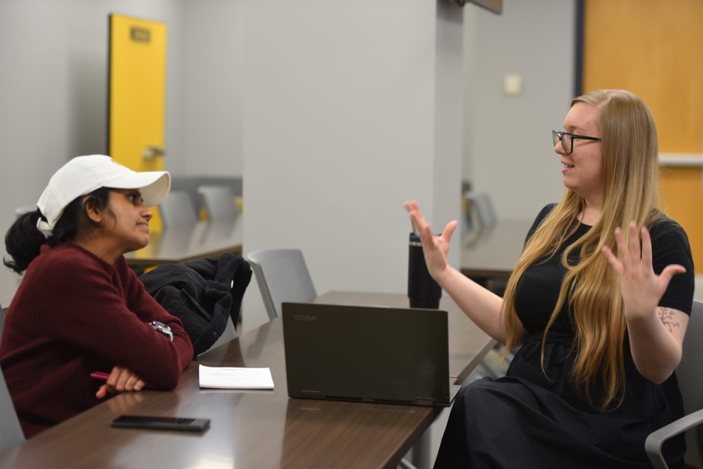 Laura Roesch coaches a grad student on her cover letter.