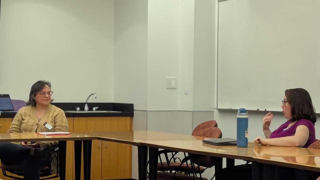 Liz Bent discusses projects with a graduate student