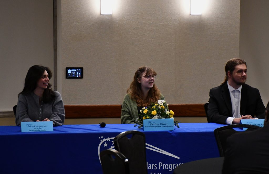 Three panelists sitting at a table. Two women and one man, from left to right: Nicole Amezcua Morfin, Desiree Dixon, Christian Jones