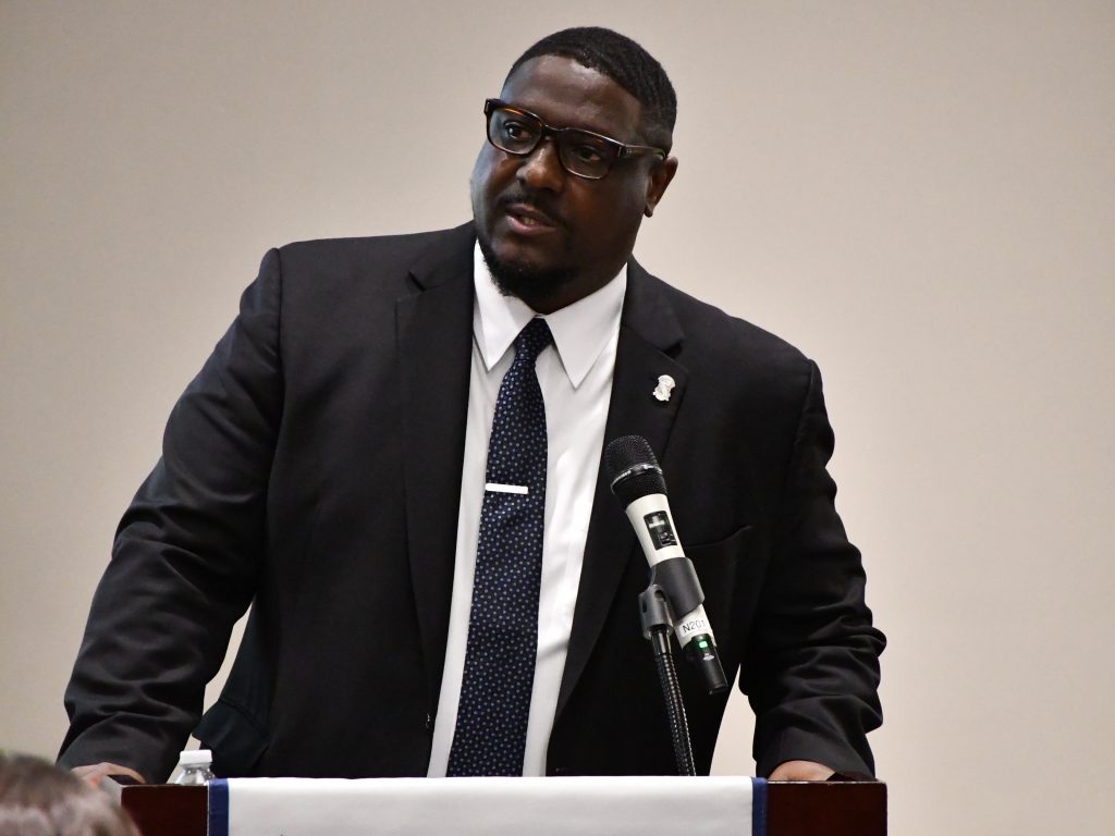 Dr. Freddie Wills, Jr. speaking while standing at a podium