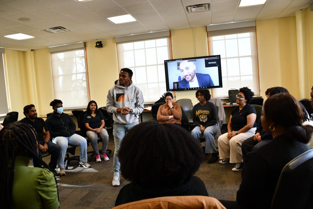 Graduate students participate in a group activity led by a virtual presenter