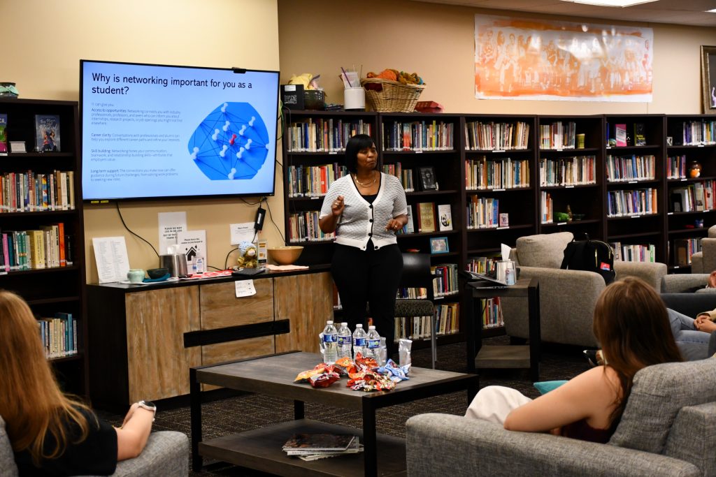Female staff member leads an informal presentation for a small group of students