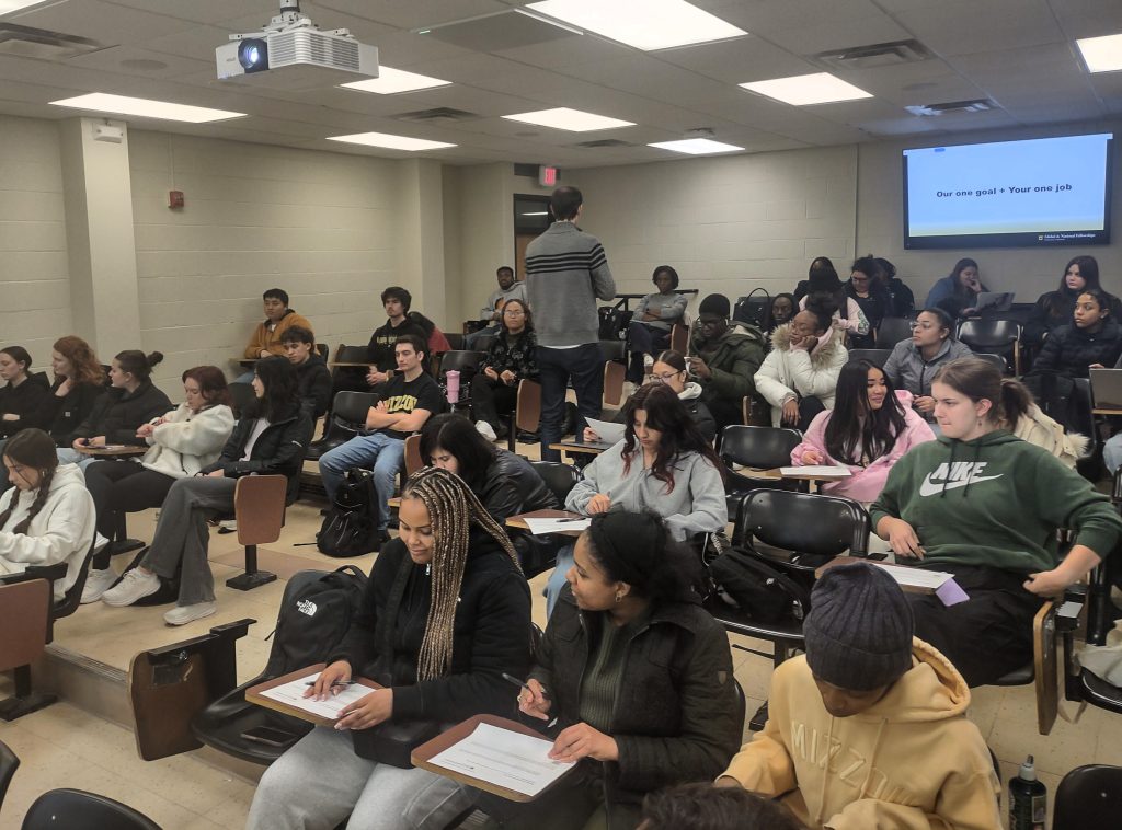 a classroom full of college students during a speaker's presentation