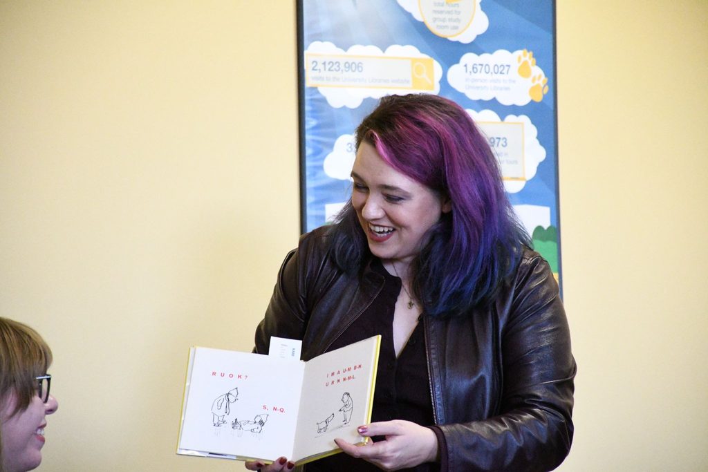 Emily Friedman holds up a children's activity book from Special Collections. 