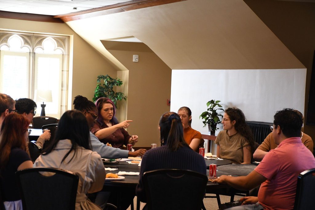 Grad students have lunch with Emily Friedman during the Week of Writing. 